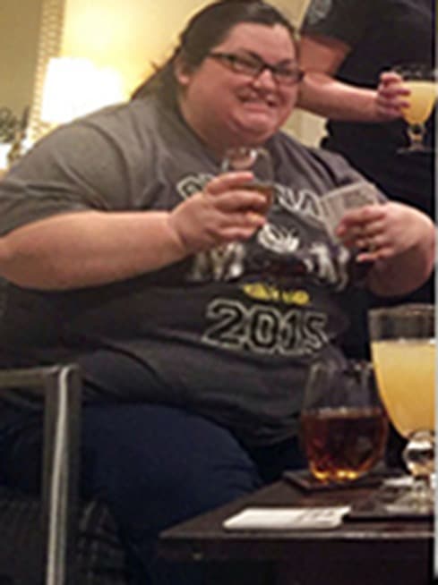 Chrissy in 2015, seated at a table with a drink